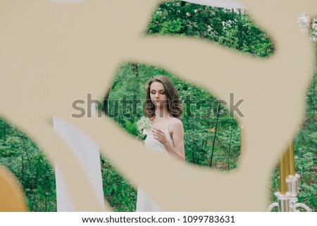 Very beautiful girl photographed in nature with fresh flowers.