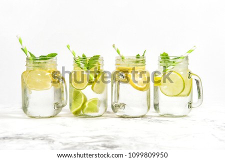 Fresh drink with lime, lemon, mint and ice. Cold summer lemonade