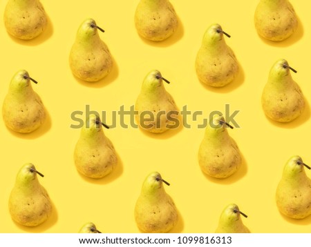 Unusual creative modern trendy photo with pear on the yellow background