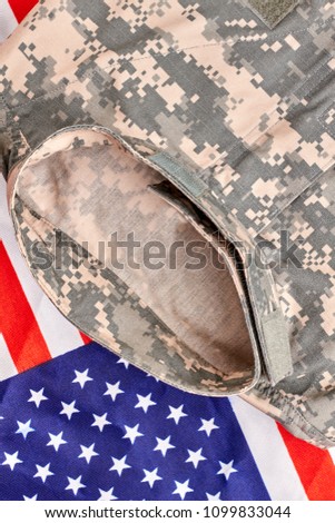 Camouflage clothes and us flag, close up. Top view.