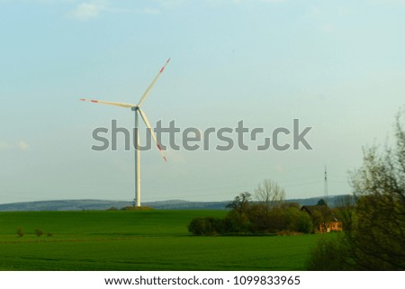 Windmill in the field. Concept of renewable energy, energy substitution and ecology