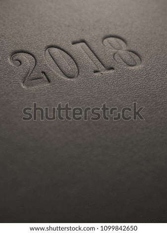 2018 embossed on a dark background with space for text