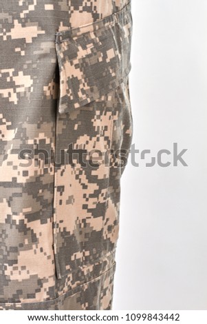 Military camouflage clothes close up. White isolated background.