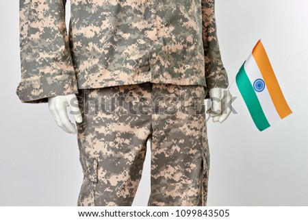 Mannequin soldier with indian flag. Cropped image. White isolated background.