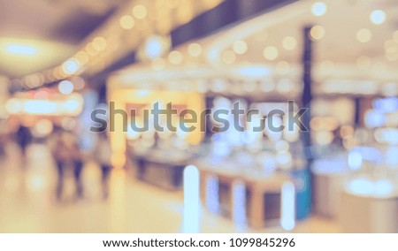 Abstract blur image of People walking at shopping mall with bokeh for background usage . (vintage tone)