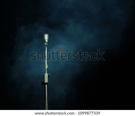 Microphone in a smoke on a dark background, in club 