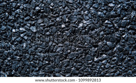 Texture of black stone wall captured with a daylight.