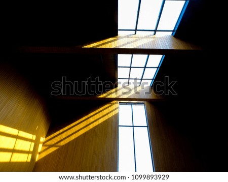 The light of the abstract photo is across the window of the building.