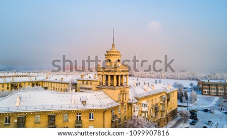 Aerial photo of Magnitogorsk city, with snowy roofs on beautiful buildings, historical architectural ensemble, winter evening, sunset, Ural, Russia