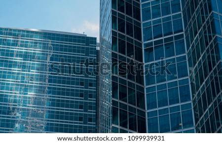 modern glass and steel office buildings in lower manhattan with blue sky