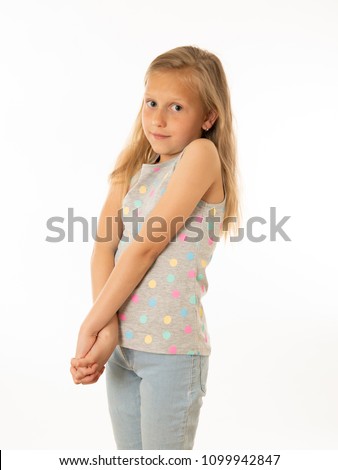 Close up portrait of a cute young shy girl looking timid at the camera on a white background. In facial expression photo concept