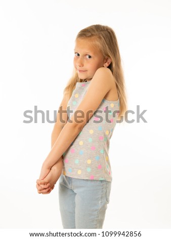 Close up portrait of a cute young shy girl looking timid at the camera on a white background. In facial expression photo concept