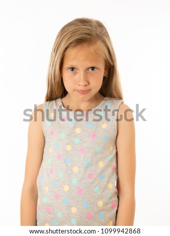 Portrait of a pretty bullied, depressed, alone, tired, stressed young child looking unhappy and sad. Isolated withe background. Human emotions, facial expressions, body language and bulling