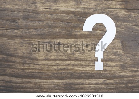 question mark on a wooden table