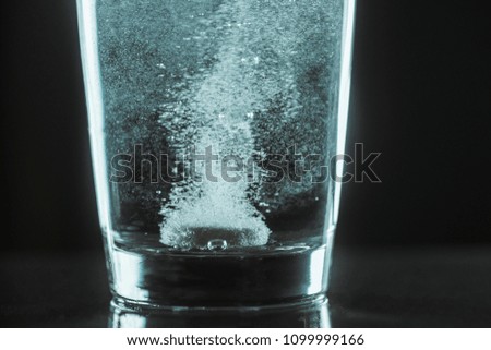 Tablet dissolving in water. Concept - headache, cold, medicine, medicine