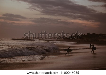 Surfers at Sunset on Canggu beach Bali