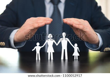 Insurer protecting a family with his hands