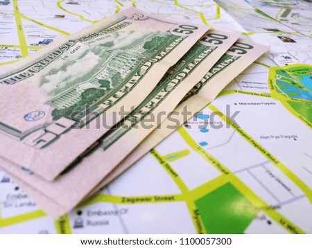 Dollar banknotes on background of map.