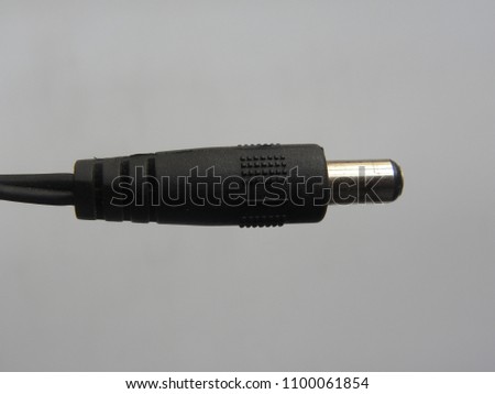 Black color male jack of power plug adapter on white background