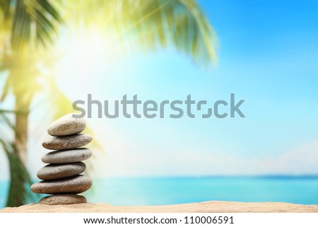 Stack of zen stones on sand beach Royalty-Free Stock Photo #110006591