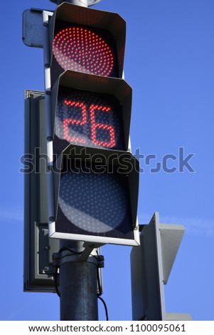 Red traffic light  with a beautiful blue sky in background