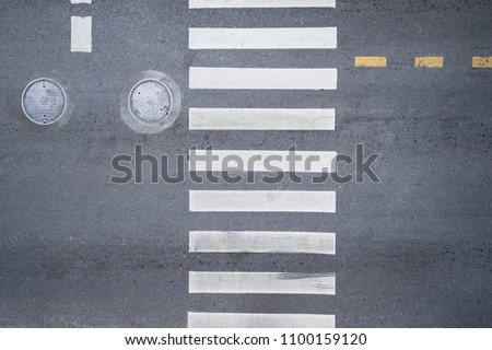 Aerial photo top view over pedestrian crossing on traffic road Royalty-Free Stock Photo #1100159120