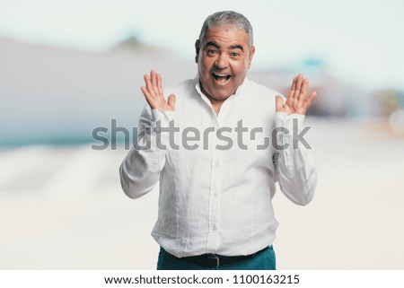 Middle aged man surprised and shocked, looking with wide eyes, excited by an offer or by a new job, win concept
