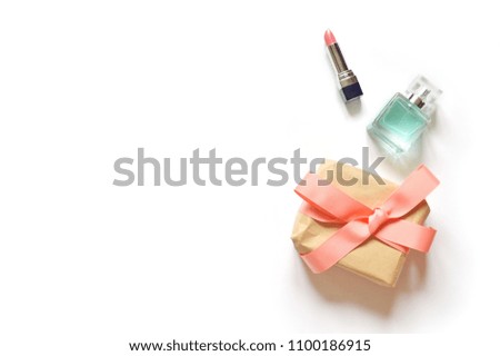 Pink lipstick, gift box and women's perfume. Flat lay beauty photo. Copy space