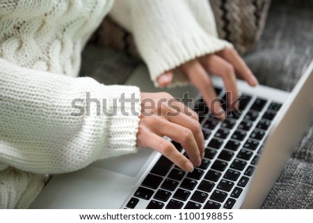 Hands of woman typing on keyboard, teen girl working on computer searching online, commenting in social network, using application on laptop, chatting with friend, writing post in blog, close up view