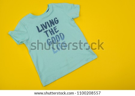  boys summer colored apparel. Set of trendy cartoon t-shirts for boys on yellow  background, top view. Kids summer apparel on sale.