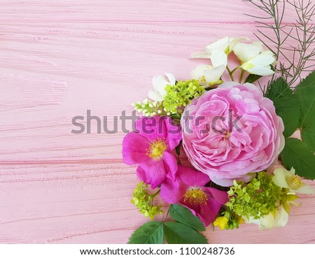 roses beautiful bouquet frame on a pink wooden background jasmine, magnolia