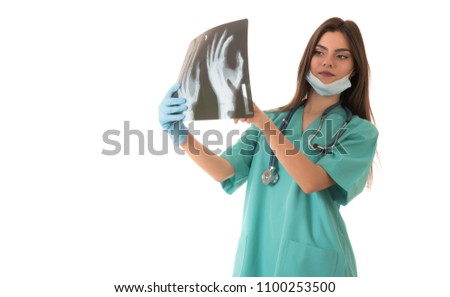 Young female doctor looking at the x-ray picture. isolated on white