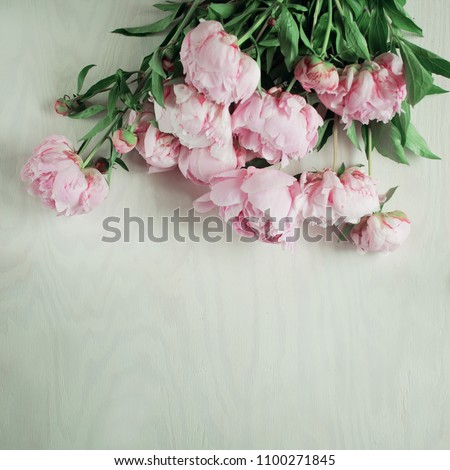 Beautiful pink, rose peonies on wood plate, can be used as background