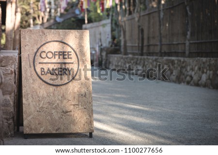 Sign at coffee shop, plywood texture signboard tell coffee and bakery
