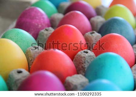 Rows of brightly colored traditional Easter eggs ready for the Easter bunny to hide.