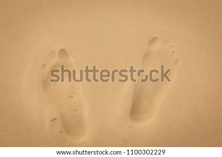 Copy space of footprint on sand beach texture abstract background. Summer vacation and business travel freedom adventure concept. Vintage tone filter effect color style.
