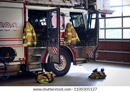 Fire truck in the firestation Royalty-Free Stock Photo #1100305127