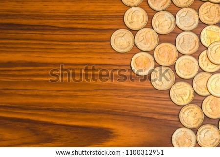 Stack of coin on wooden working table, business and finance concept idea.