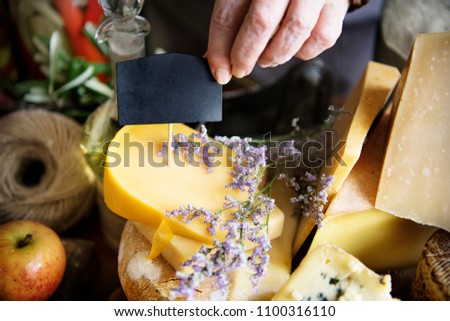 Stacked hard cheese in a beautiful spring setting and a label copy space for the cheese