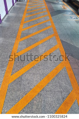 Yellow lines area on floor, walkway for stop and waiting transpiration like sky train or bus. 
