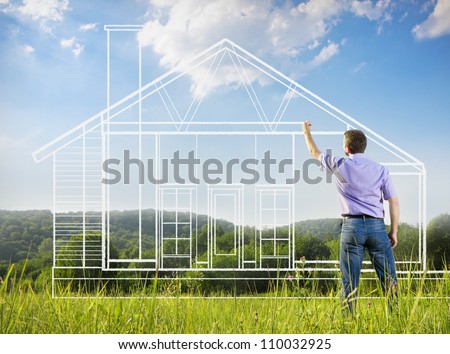 Man drawing a house in a field Royalty-Free Stock Photo #110032925