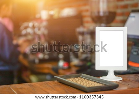 Empty brown wooden table and Coffee shop interior with Mock up Menu frame in Bar restaurant.