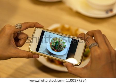 woman photographing food by smartphone. Social Concepts