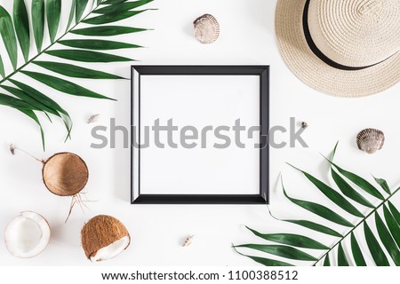 Summer composition. Tropical palm leaves, hat, photo frame, coconut on white background. Summer concept. Flat lay, top view, copy space