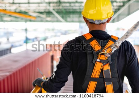Construction worker wearing safety harness and safety line working on construction Royalty-Free Stock Photo #1100418794