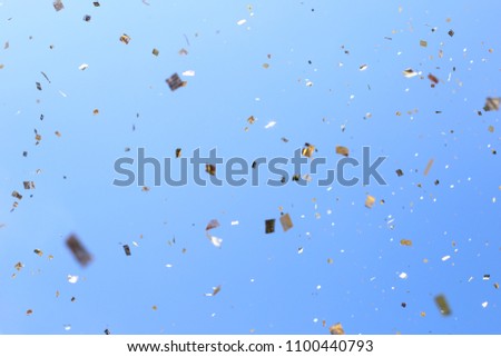 Confetti flies in the air against the sky. The atmosphere of the festival and festival.
