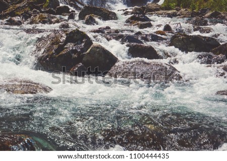 River coast with stones. turbulent water flow over rocks in a mountain river