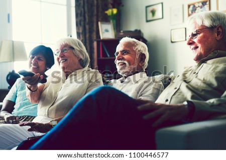 Senior people watching television in the living room