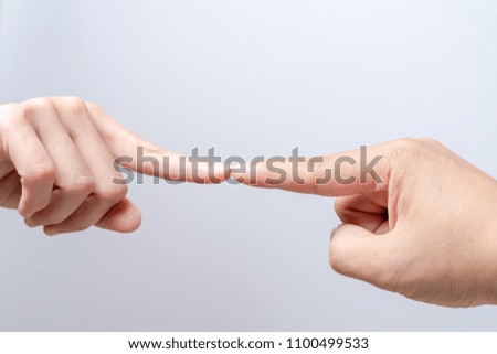 finger point touching men and women hands reaching towards each other. Diversity differential concept