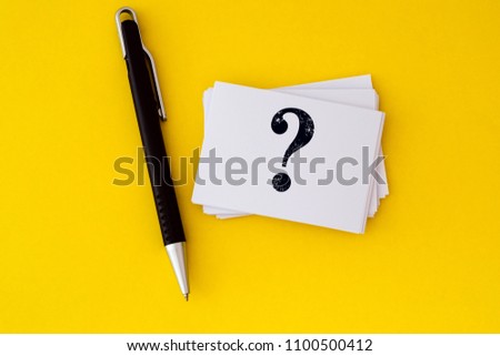 stacking of a white business card with written question mark symbol  on vibrant yellow background , Questions and Answers or Q&A concept design